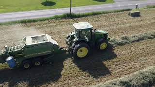 New Holland and John Deere baling hay together on a beautiful summer day