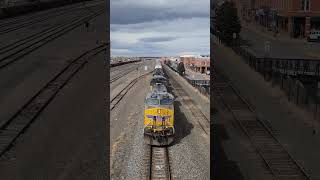 A Union Pacific train passes under a pedestrian walkway in Laramie, WY. #train #unionpacific