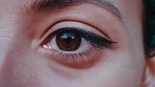 Extreme close up of a 24 year old woman’s eye blinking, standing in Marrakech during magic hour,