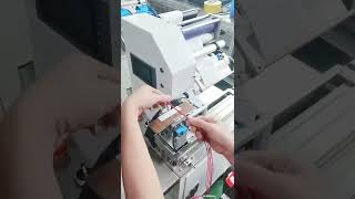 Cable flag stickering machine