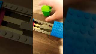 Lego garbage truck picking up bins