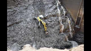 Menzi Muck M545 digging out a reservoir in Switzerland on a extrem steep slope