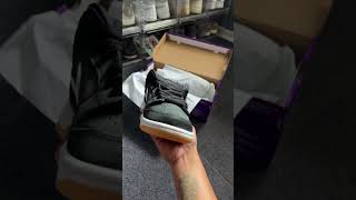 On-hand look of the SB Dunk Low Pro Black and Gum