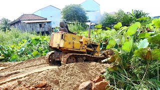 Road cross the lake ..! Mini dozer is push sand to water before dump soil