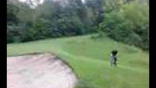 tom jumpin sand trap at a golf course