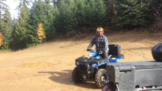 Polaris Sportsman 400 ATV Riding thru some mud.