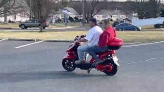 Stealth Electric scooter for two adults having fun trying their new scooter