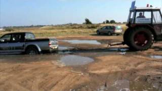 Tractor pulling a 4x4 out of the mud