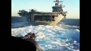 Helicopter makes close flyby on U.S aircraft carrier!