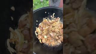 Cooking in a large cauldron Meat Mushrooms Potatoes.