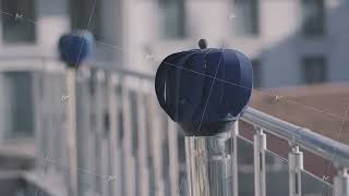 Two rotating blue small windmills in a form of sphere outdoors at the balcony. Action. Decoration of