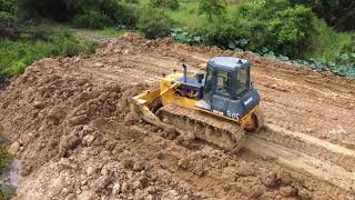 Great​​​​​ work operator bulldozer SHANTUI SD16E pushing soil mix mud with dump track spreading soil