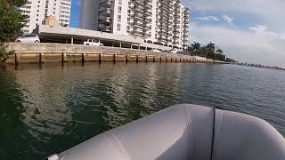 Cruising in marina on a small dinghy at Miami Biscayne Bay