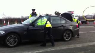 Gardai searching a car during a Motorway check