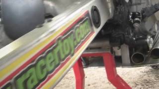 Harold Waddells Father Gary Adjusts Tire Chain at Logan Hillclimb