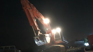 Loading excavator at night. Close to transmission lines!