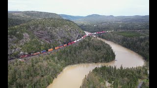 Across the bridge and along the lake (AERIAL) ~ CPKC train 101-25 at Neys, Ontario, Canada