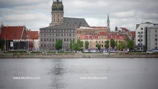 View through the Daugava River of Saint Peter's Church against the background of the cloudy sky