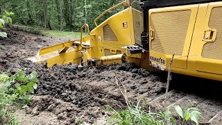 Komatsu stuck in mud, difficult root leveling conditions