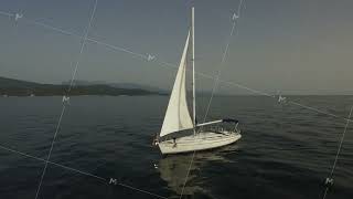 Aerial view of sailboat at sea. Footage. Sail Boat on Ocean aerial view. Beautiful aerial view of