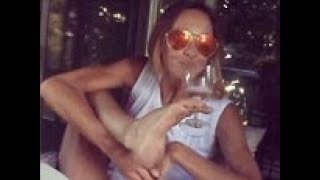 Sharni Vinson drinks from a wine glass using her foot