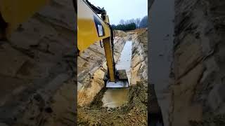 The process of digging a canal by an excavator