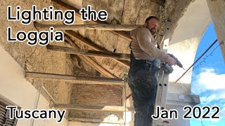 Lighting the columns on an ancient Tuscan villa loggia.