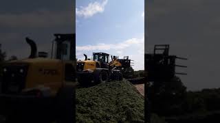 New Holland W170D wheel loader clamping next to the wall