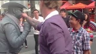 Douche gets punched by street performer!