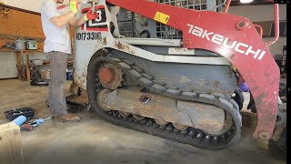 Replacing worn front roller on Takeuchi TL8 Skid Steer