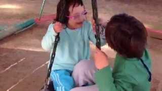 Genev'e and Noah on swing