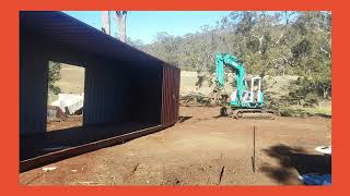 Moving shipping containers with excavator