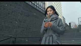 Portrait of Asian woman typing on mobile phone outdoors. A close-up girl walks up the stairs with a