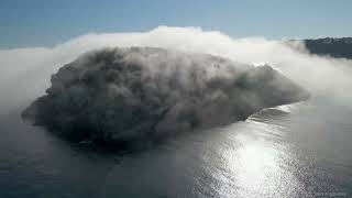 Spain coast- Sea fog over the Island of Portixol,Javea,Blanca