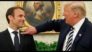 Trump flicks dandruff from Macron's suit