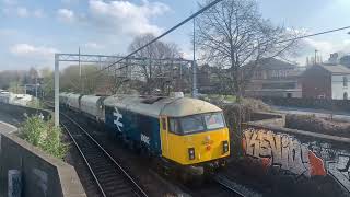 Class 69002 Tom Miller & 66796 The Green Progressor passes Smethwick Rolfe Street 28th March 2022