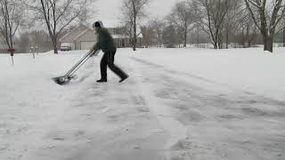 Wheeled Snowcaster Shovel In Action Clearing Driveway of Snow