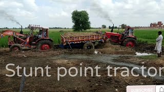 Belarus with heavy loaded truly in mud of the stuck is pulling out help in other tractor 1.m