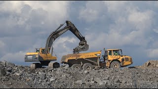 Volvo 250  excavator is loading Volvo truck