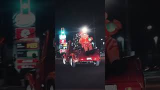 A little red truck, hauling a Christmas tree!