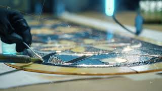 Close-up Soldering of stained glass seams. Artist's hands. Stained glass workshop, needlework