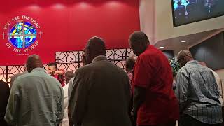 Pastor Janae praying over thevmen on Father's Day