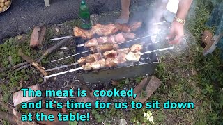 WE PREPARE A DELICIOUS BARBECUE FROM MEAT AND VEGETABLES IN THE NATURE ON THE GRILL.