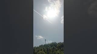 Jet airplane with trail against the blue sky