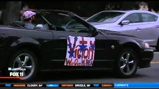 LAPD Slowly Chase Man In Convertible With 'Victory Parade' Sign