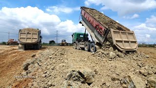 Operator bulldozer skiller pushing soil with heavy dump track 25T spreading soil into water