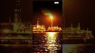 FPSO Tanker Vessel Near Oil Platform At Night.