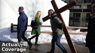 Anti-WEF Christian carries a huge cross to the gates of the 2024 WEF Meeting in Davos