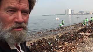 Beach of plastic waste and volunteer clean-up team, Manila Bay, Philippines