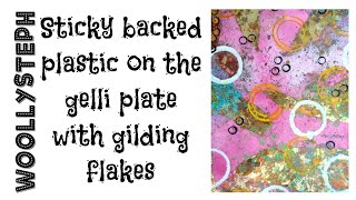 Sticky backed plastic on the gelli plate with gilding flakes